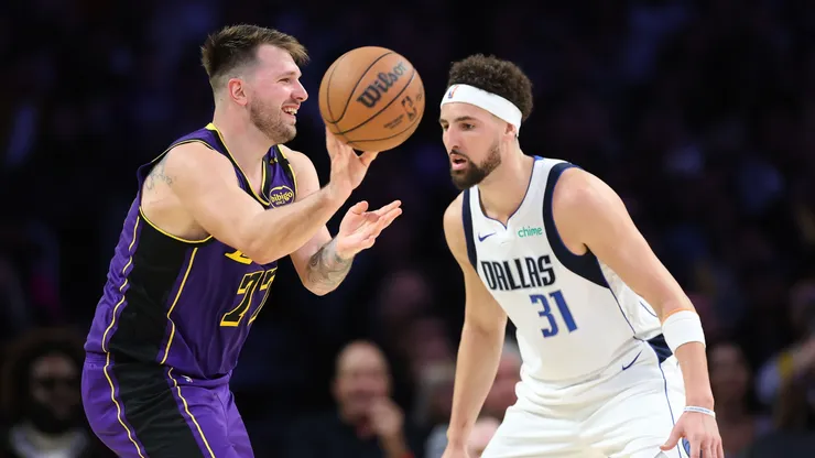 Luka Doncic #77 of the Los Angeles Lakers passes past Klay Thompson #31 of the Dallas Mavericks during the first half of a game at Crypto.com Arena on February 25, 2025 in Los Angeles, California.