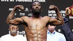 Terence Crawford poses on the scale during the weigh-in.