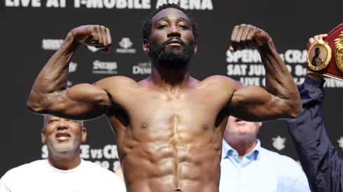 Terence Crawford poses on the scale during the weigh-in.