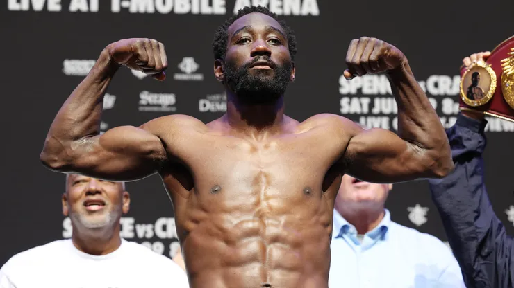 Terence Crawford poses on the scale during the weigh-in.