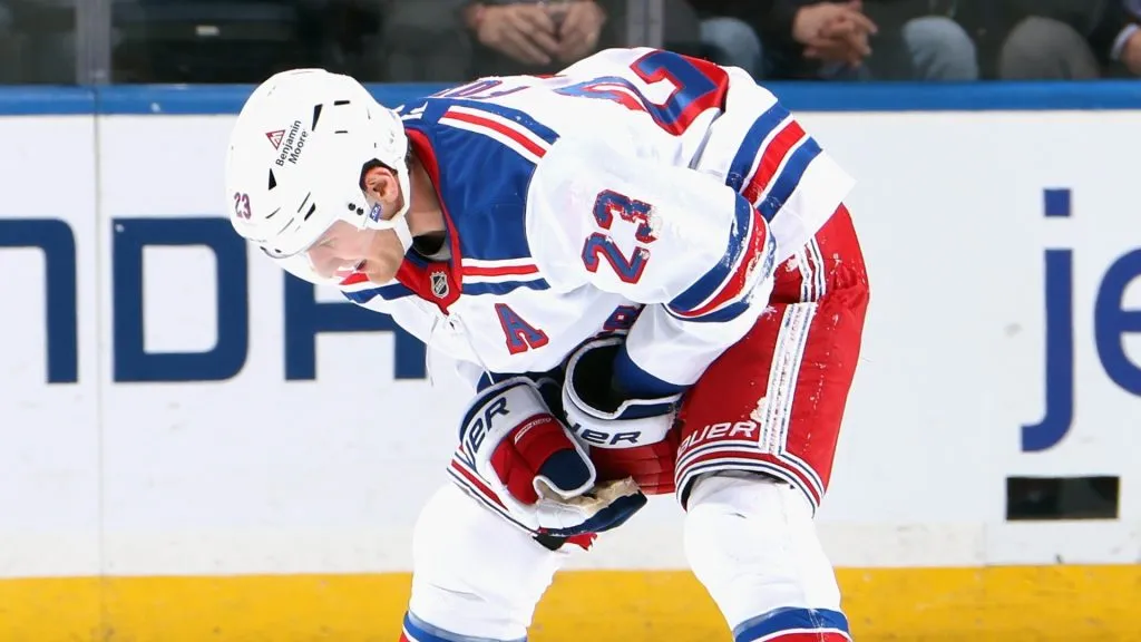 Adam Fox #23 of the New York Rangers leaves the ice after an injury during the third period against the New York Islanders at UBS Arena on February 25, 2025 in Elmont, New York.