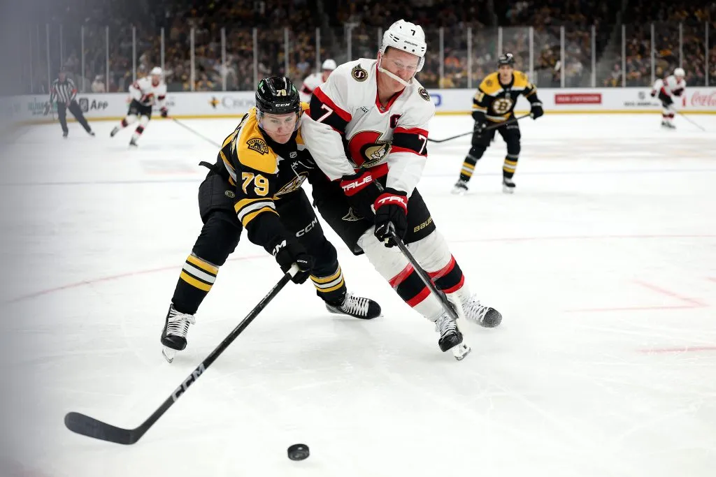 Michael Callahan #79 of the Boston Bruins and Brady Tkachuk #7 of the Ottawa Senators