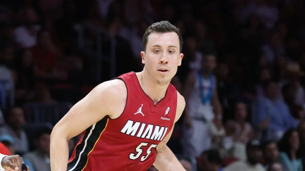 Duncan Robinson #55 of the Miami Heat drives against Terance Mann #14 of the Atlanta Hawks