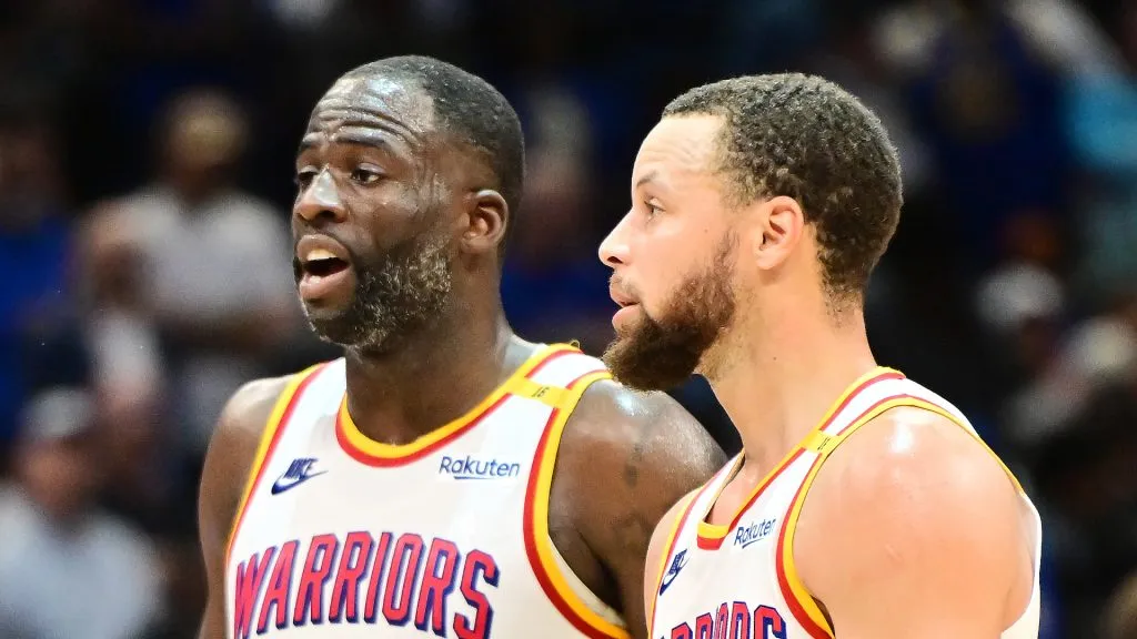 Draymond Green #23 and Stephen Curry #30 of the Golden State Warriors react in the second half against the Orlando Magic
