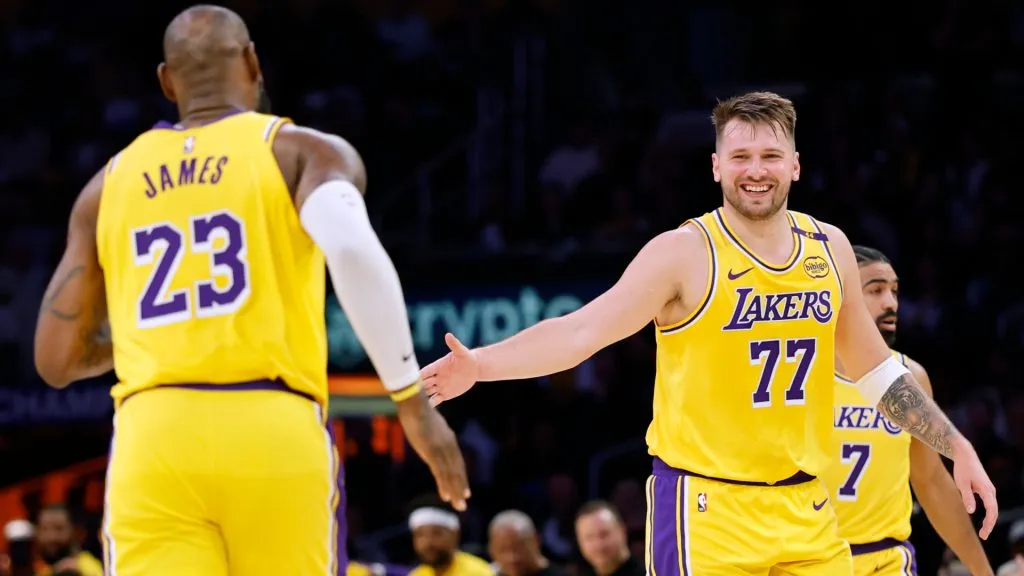 Luka Doncic #77 of the Los Angeles Lakers reacts to his pass to LeBron James #23 during the first half at Crypto.com Arena. (Harry How/Getty Images)