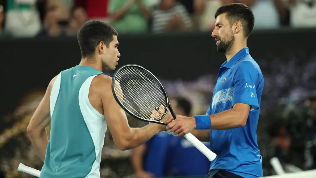 Novak Djokovic embraces Carlos Alcaraz following victory in the Men’s Singles Quarterfinal match during day 10 of the 2025 Australian Open.