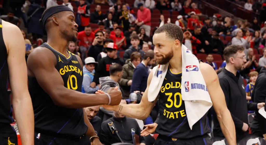 Jimmy Butler #10 and Stephen Curry #30 of the Golden State Warriors celebrate after the game against the Chicago Bulls at the United Center on February 08, 2025 in Chicago, Illinois.