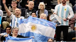 Fans of Argentina cheer whilst waving a flag
