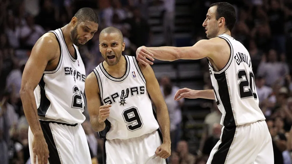 Tony Parker reacts with Tim Duncan and Manu Ginobili against the Dallas Mavericks in Game Three of the 2010 Western Conference Quarterfinals. (Ronald Martinez/Getty Images)