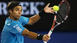 Fernando Gonzalez plays a backhand in his fourth round match against Andy Roddick during the 2010 Australian Open.