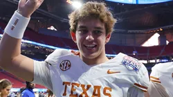 Arch Manning #16 and Cole Lourd #19 of the Texas Longhorns celebrate after defeating the Arizona State Sun Devils 39-31 during the second overtime in the Chick-fil-A Peach Bowl at Mercedes-Benz Stadium on January 01, 2025 in Atlanta, Georgia.