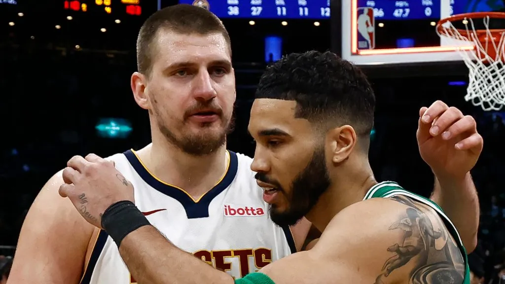 Jayson Tatum #0 of the Boston Celtics hugs Nikola Jokic #15 of the Denver Nuggets after their game at TD Garden