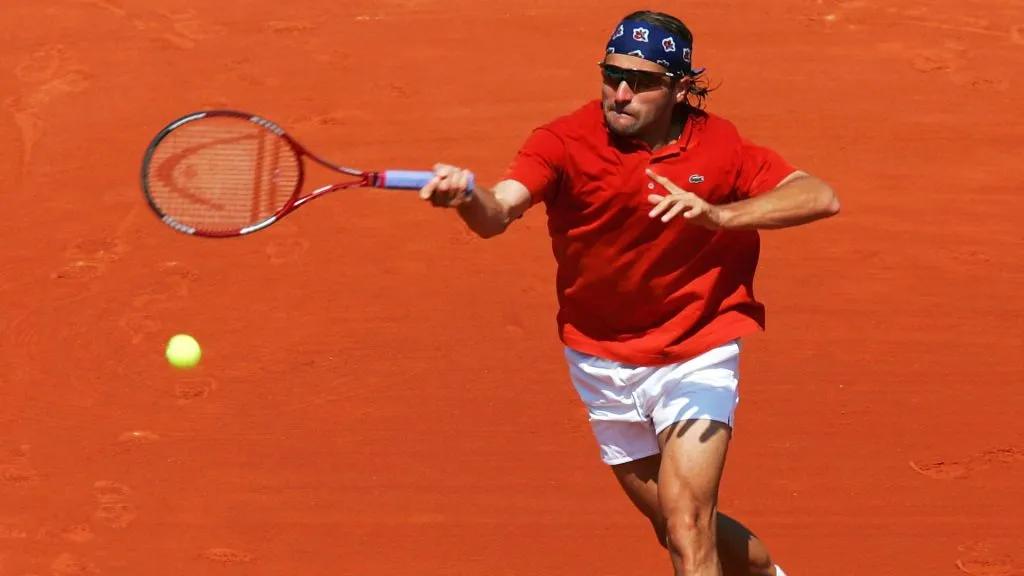 Arnaud Clement of France returns in his first round match against Fabrice Santoro of France during Day Two of the 2004 French Open Tennis Championship. (Source: Clive Brunskill/Getty Images)