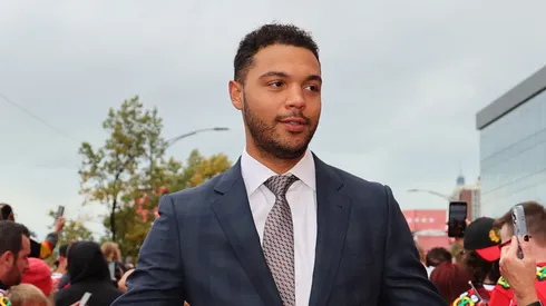 Seth Jones #4 of the Chicago Blackhawks high fives fans as he walks the red carpet prior to the game against the Vegas Golden Knights at the United Center on October 21, 2023 in Chicago, Illinois.