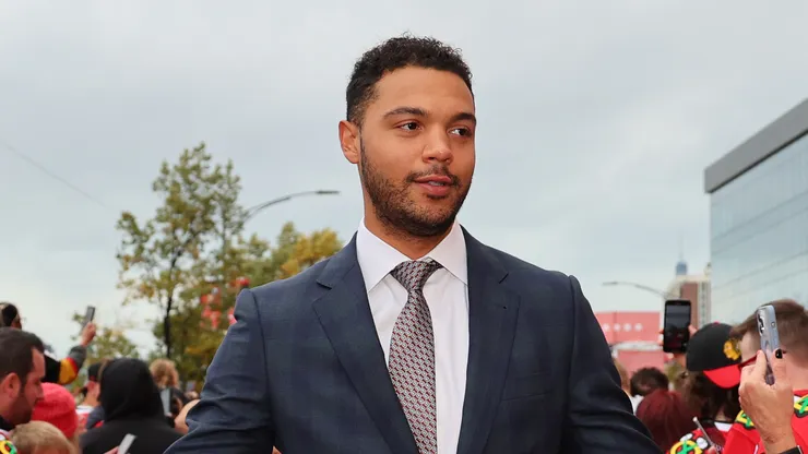 Seth Jones #4 of the Chicago Blackhawks high fives fans as he walks the red carpet prior to the game against the Vegas Golden Knights at the United Center on October 21, 2023 in Chicago, Illinois.