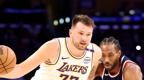 Luka Doncic #77 of the Los Angeles Lakers dribbles the ball as Kawhi Leonard #2 of the LA Clippers