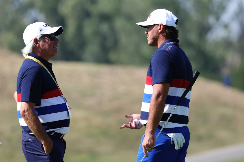 Fred Couples, Vice Captain of Team United States speaks with Brooks Koepka of Team United States
