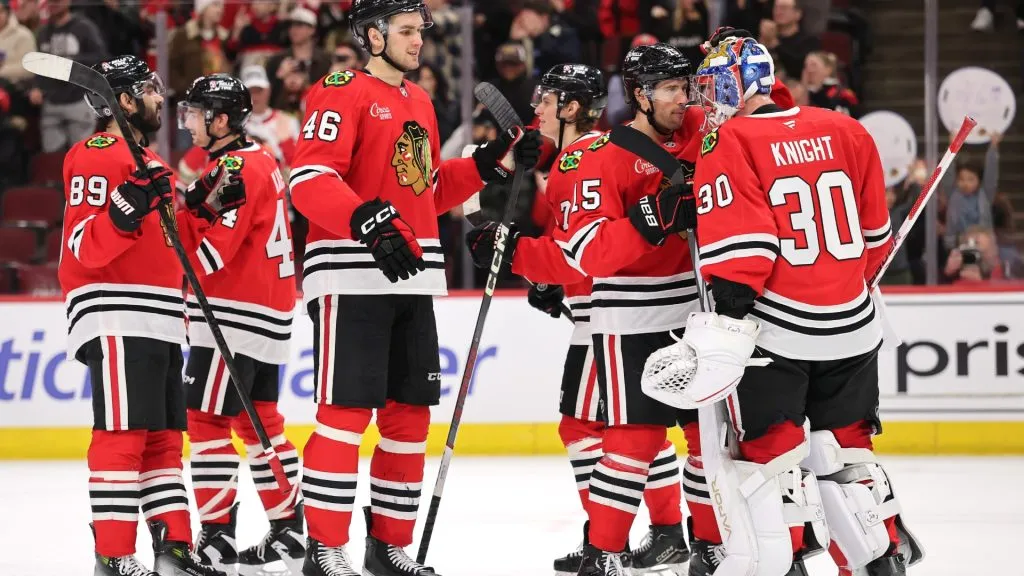 Spencer Knight #30 of the Chicago Blackhawks celebrates with teammates after defeating the Los Angeles Kings at the United Center on March 03, 2025 in Chicago, Illinois. (Photo by Michael Reaves/Getty Images)