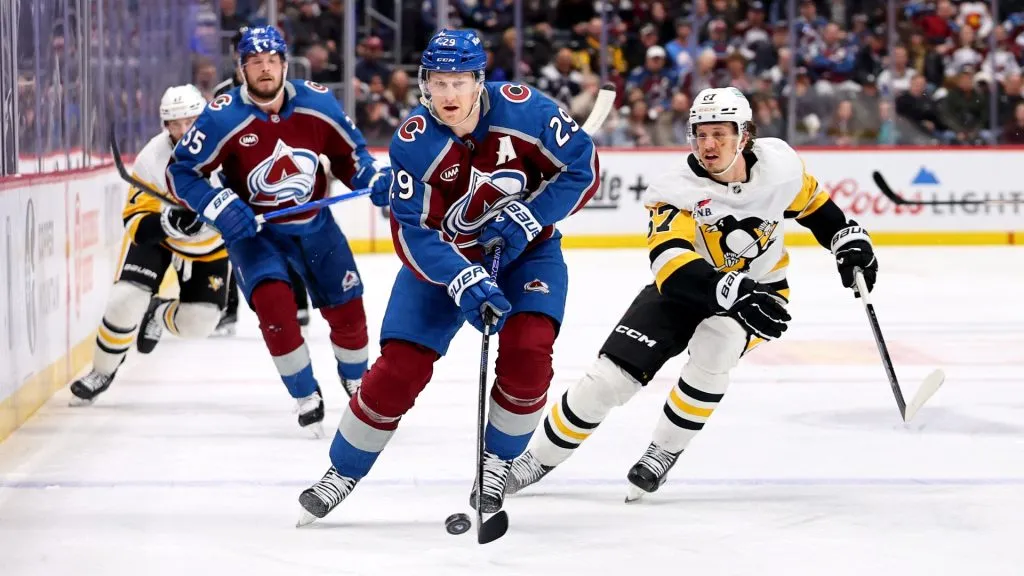 Nathan MacKinnon #29 of the Colorado Avalanche skates past Rickard Rakell #67 of the Pittsburgh Penguins in the first period at Ball Arena on March 4, 2025 in Denver, Colorado. (Photo by Jamie Schwaberow/Getty Images)