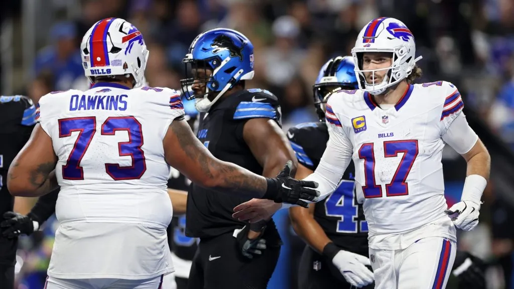 Dion Dawkins #73 and Josh Allen #17 of the Buffalo Bills celebrate after scoring a touchdown in the second quarter against the Detroit Lions at Ford Field on December 15, 2024 in Detroit, Michigan.