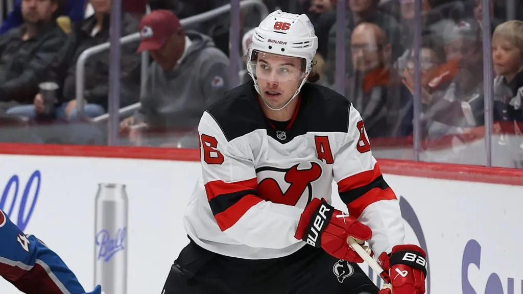 Jack Hughes #86 of the New Jersey Devils brings the puck off the boards against Calvin de Haan #44 of the Colorado Avalanche in the first period at Ball Arena on February 26, 2025 in Denver, Colorado.