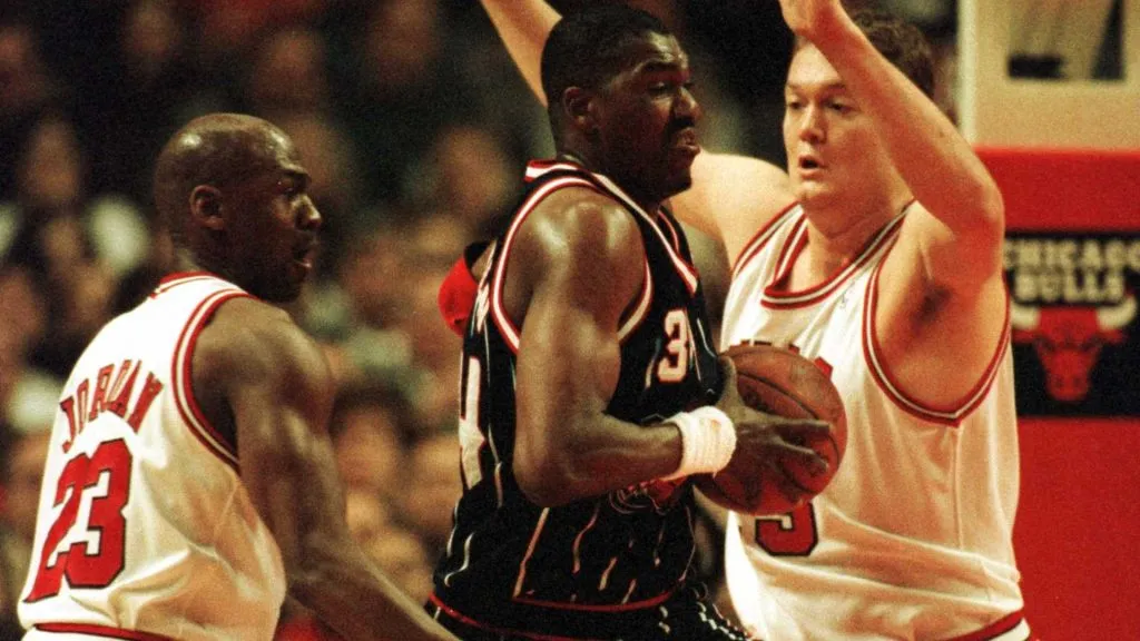 Hakeem Olajuwon guarded by Michael Jordan and Luc Longley during a game between the Houston Rockets and the Chicago Bulls on January 3, 1996.