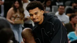 Victor Wembanyama #1 of the San Antonio Spurs greets Chris Paul before the start of the first half against the Oklahoma City Thunder at Frost Bank Center on March 2, 2025 in San Antonio, Texas.