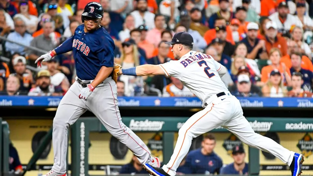 Alex Bregman #2 tags out Rafael Devers #11 of the Boston Red Sox in the second inning at Minute Maid Park on August 24, 2023 in Houston, Texas. (Photo by Logan Riely/Getty Images)