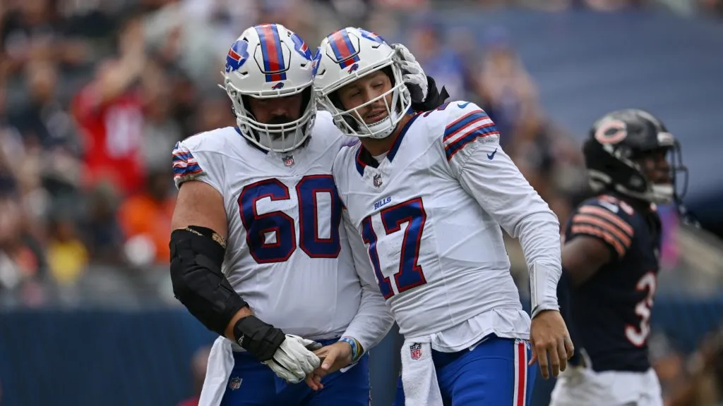 Mitch Morse #60 and Josh Allen #17 of the Buffalo Bills celebrate after a touchdown in the first half of a preseason against the Chicago Bears at Soldier Field on August 26, 2023 in Chicago, Illinois.