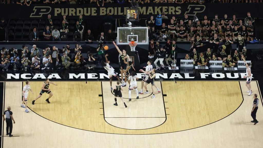 Tristen Newton  attempts a shot while being guarded by Zach Edey in the first half during the NCAA Men’s Basketball Tournament National Championship game in 2024. (Source: Jamie Squire/Getty Images)
