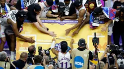 Kansas Jayhawks players place the team in the center of the bracket after defeating the North Carolina Tar Heels during the 2022 NCAA Men's Basketball Tournament National Championship.