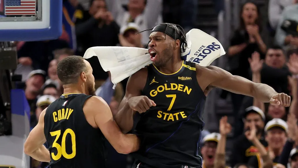 Stephen Curry #30 and Buddy Hield #7 of the Golden State Warriors react after Curry made a three-point basket