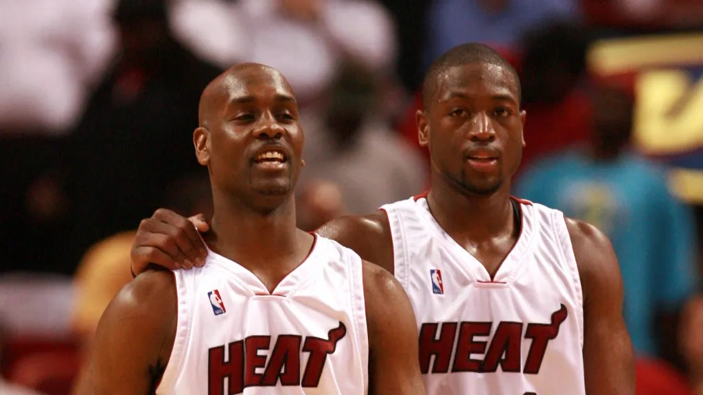  Gary Payton #20 of the Miami Heat walks with his teammate Dwyane Wade #3 during the game against the Cleveland Cavaliers