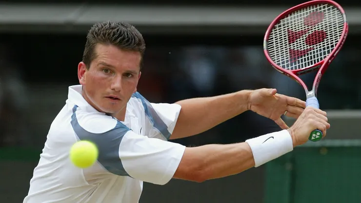 Richard Krajicek of the Netherlands in action against Xavier Malisse of Belgium during the mens quarter final match at 2002 Wimbledon.