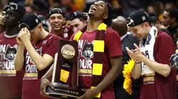 Donte Ingram #0 of the Loyola Ramblers celebrates with the trophy after defeating the Kansas State Wildcats during the 2018 NCAA Men's Basketball Tournament South Regional.