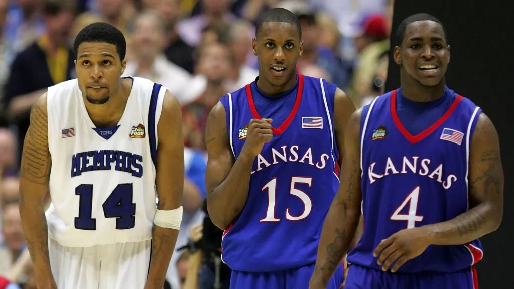 Mario Chalmers reacts in overtime along with teammate Sherron Collinsas Chris Douglas-Roberts of the Memphis Tigers looks on during the 2008 NCAA Men’s National Championship game. (Source: Ronald Martinez/Getty Images)