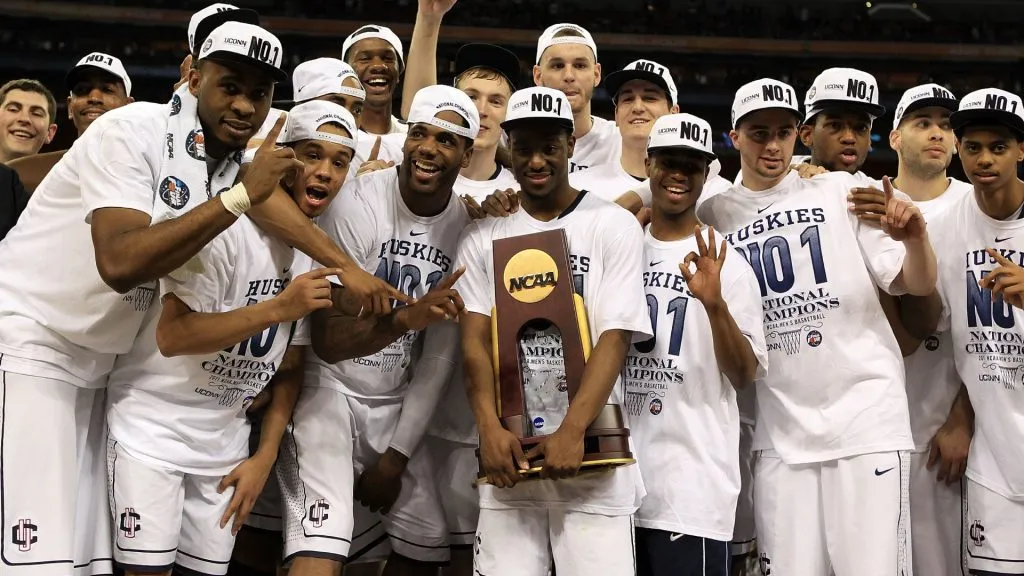 Kemba Walker holds the trophy as he and his team celebrate after defeating the Butler Bulldogs to win the National Championship Game of the 2011 NCAA Division I Men’s Basketball Tournament. (Source: Streeter Lecka/Getty Images)