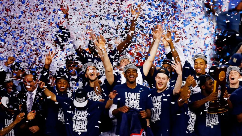The Connecticut Huskies celebrate after defeating the Kentucky Wildcats 60-54 in the NCAA Men’s Final Four Championship at AT&T Stadium on April 7, 2014. (Source: Tom Pennington/Getty Images)