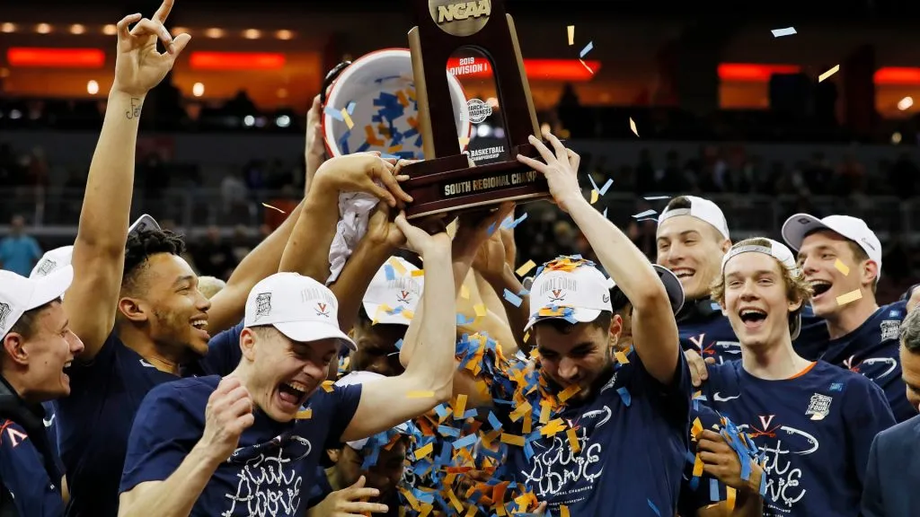 The Virginia Cavaliers raise the trophy after defeating the Purdue Boilermakers 80-75 in overtime of the 2019 NCAA Men’s Basketball Tournament South Regional. (Source: Kevin C. Cox/Getty Images)