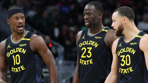 Jimmy Butler #10, Draymond Green #23 and Stephen Curry #30 of the Golden State Warriors walk backcourt during a game against the Milwaukee Bucks.