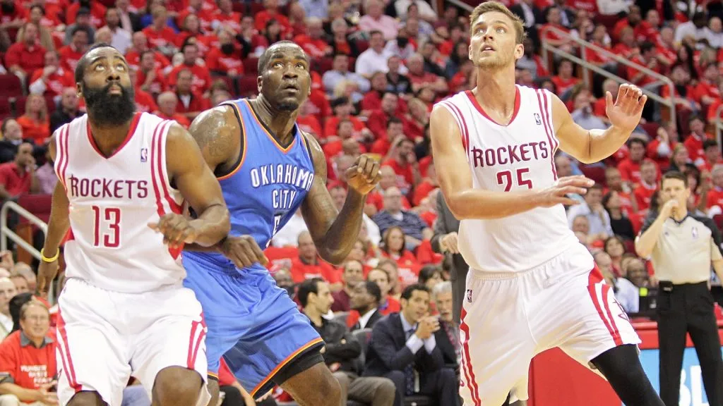 James Harden and Chandler Parsons of the Houston Rockets, and Kendrick Perkins of the Oklahoma City Thunder look for a rebound on April 29, 2013.