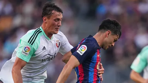Pedri of FC Barcelona is fouled by Jorge Herrando of CA Osasuna, who is later shown a red card