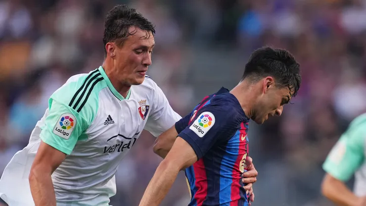 Pedri of FC Barcelona is fouled by Jorge Herrando of CA Osasuna, who is later shown a red card