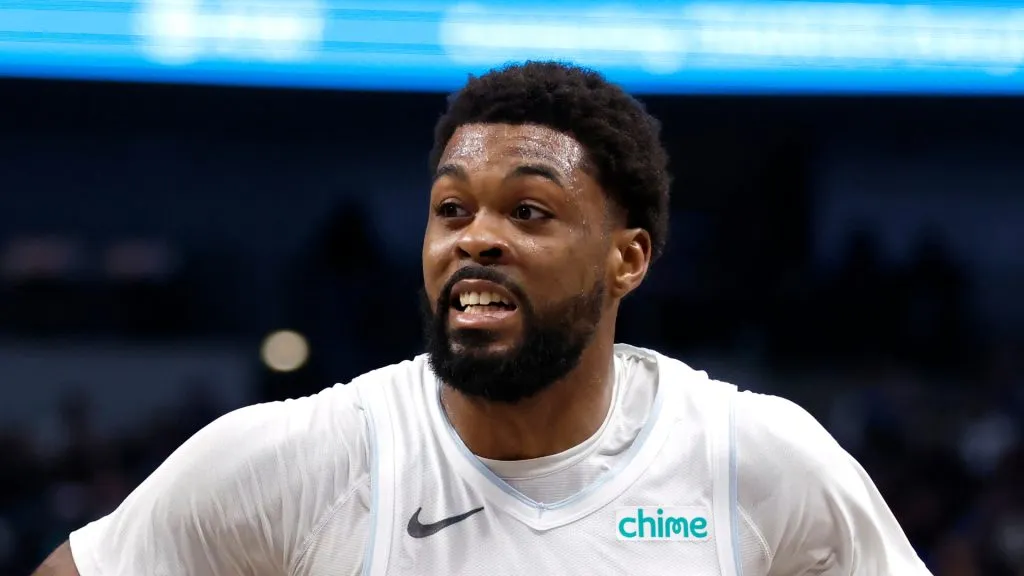 Naji Marshall #13 of the Dallas Mavericks drives to the basket as Royce O'Neale #00 of the Phoenix Suns