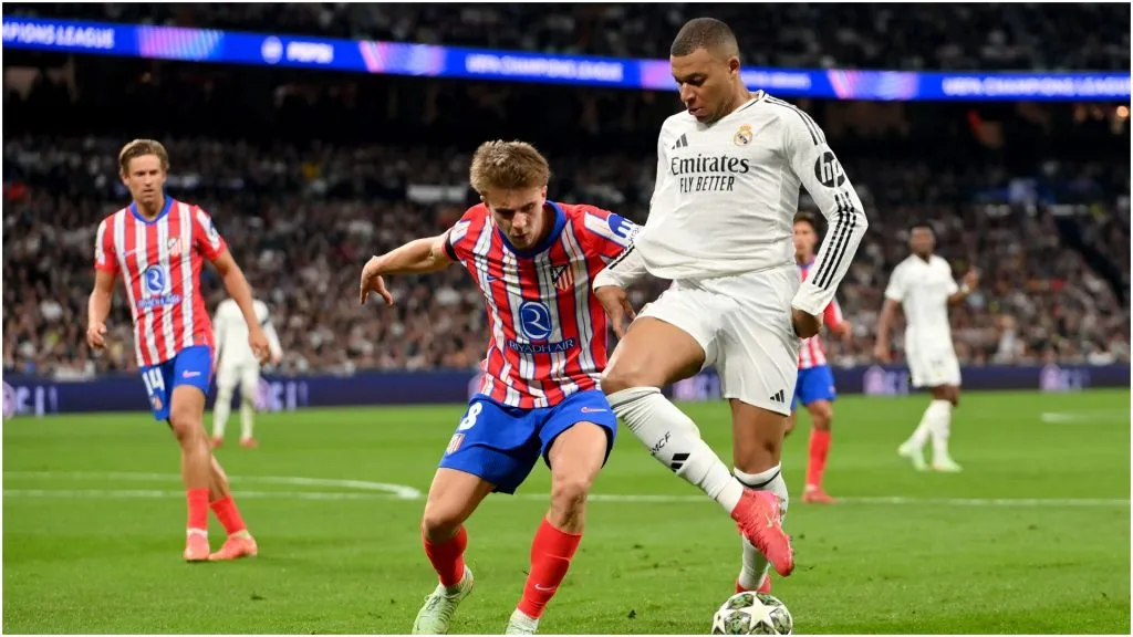Kylian Mbappe of Real Madrid is challenged by Pablo Barrios of Atletico de Madrid – Denis Doyle/Getty Images