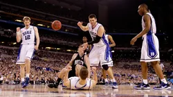 The Duke Blue Devils celebrate after Scheyer drew a charging foul against Gordon Hayward #20 of the Butler Bulldogs during the 2010 NCAA Division I Men's Basketball National Championship game.
