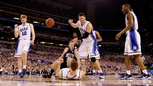 The Duke Blue Devils celebrate after Scheyer drew a charging foul against Gordon Hayward #20 of the Butler Bulldogs during the 2010 NCAA Division I Men's Basketball National Championship game.