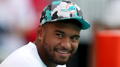 Tua Tagovailoa #1 of the Miami Dolphins looks on from the bench prior to a game against the Philadelphia Eagles at Hard Rock Stadium on August 27, 2022 in Miami Gardens, Florida.