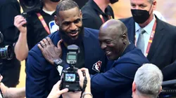 Michael Jordan and LeBron James hug after the presentation of the NBA 75th Anniversary Team on February 20, 2022 in Cleveland, Ohio.