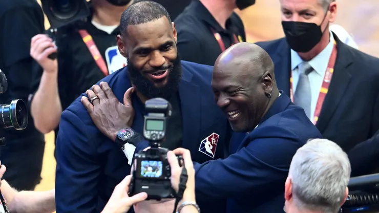 Michael Jordan and LeBron James hug after the presentation of the NBA 75th Anniversary Team on February 20, 2022 in Cleveland, Ohio.
